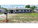 Charming single-story home featuring a gray exterior, metal roof, and a well-maintained front yard at 1406 Hope Ct, Tavares, FL 32778
