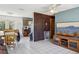 Open-concept living room showcasing tile flooring, modern lighting, and a partial view of the kitchen at 1406 Hope Ct, Tavares, FL 32778