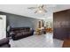 Spacious living room featuring tile floors, ceiling fan, wood paneling, a comfortable sofa and dining area at 1406 Hope Ct, Tavares, FL 32778