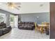 Comfortable living room with tile flooring, large windows, and an inviting atmosphere at 1406 Hope Ct, Tavares, FL 32778