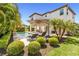 Gorgeous backyard with a refreshing pool, lounge chairs, manicured landscaping, and lush tropical palm trees at 14907 Guava Bay Dr, Winter Garden, FL 34787