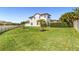 Expansive backyard with lush green lawn, white fence, and well-maintained landscaping at 14907 Guava Bay Dr, Winter Garden, FL 34787