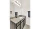 Bathroom features a dark vanity, a granite countertop, and a large mirror at 14907 Guava Bay Dr, Winter Garden, FL 34787