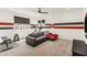 Large bonus room with red and gray accent wall, comfortable seating, and an exercise area offers a versatile living space at 14907 Guava Bay Dr, Winter Garden, FL 34787