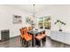 The dining room offers seating for six, modern lighting, and bright window at 14907 Guava Bay Dr, Winter Garden, FL 34787