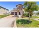 Inviting two-story home with a brick driveway, manicured lawn and two-car garage at 14907 Guava Bay Dr, Winter Garden, FL 34787