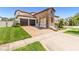 Inviting two-story home with a brick driveway, manicured lawn and two-car garage at 14907 Guava Bay Dr, Winter Garden, FL 34787