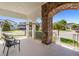 Charming front porch with stone archway and comfortable seating, perfect for enjoying the neighborhood views at 14907 Guava Bay Dr, Winter Garden, FL 34787