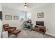 Bright home office features a modern desk setup, comfortable seating, and decor for a productive and stylish workspace at 14907 Guava Bay Dr, Winter Garden, FL 34787