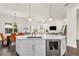 Elegant kitchen featuring an island with bar seating and open view to the dining and living areas at 14907 Guava Bay Dr, Winter Garden, FL 34787