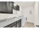 Bright laundry room features white washer and dryer, cabinetry, countertop, and a sink at 14907 Guava Bay Dr, Winter Garden, FL 34787