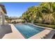 Resort style pool surrounded by lush landscaping, patio and furniture at 14907 Guava Bay Dr, Winter Garden, FL 34787