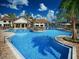 Beautiful resort-style community pool with beach entry and play area at 14907 Guava Bay Dr, Winter Garden, FL 34787