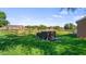 Expansive backyard with lush green grass, a wooden fence, and views of the outbuildings at 15245 Arabian Way, Montverde, FL 34756