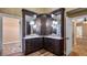 Bathroom featuring granite countertop, rich wood cabinets, pendant lighting, and tiled floor at 15245 Arabian Way, Montverde, FL 34756