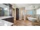 Bathroom featuring granite countertops, rich wood cabinets, pendant lighting, and a glass shower at 15245 Arabian Way, Montverde, FL 34756