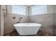 Luxurious soaking tub with contemporary fixtures, stone backsplash and modern accents at 15245 Arabian Way, Montverde, FL 34756