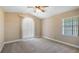 Neutral bedroom with vaulted ceiling, plush carpet, and plenty of natural light at 15245 Arabian Way, Montverde, FL 34756