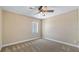 Carpeted bedroom with ceiling fan and ample natural light at 15245 Arabian Way, Montverde, FL 34756
