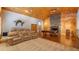 Inviting game room with stone fireplace, home theater seating, and ample space for entertainment at 15245 Arabian Way, Montverde, FL 34756