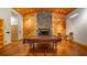 Charming game room features a fireplace, wood accents, pool table, and rustic details at 15245 Arabian Way, Montverde, FL 34756