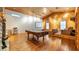 Spacious game room boasts wood paneling, pool table, stone fireplace, and elevated seating area at 15245 Arabian Way, Montverde, FL 34756