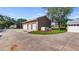 Exterior view of the detached three-car garage with driveway and manicured landscaping at 15245 Arabian Way, Montverde, FL 34756