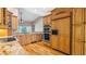 Kitchen with wooden cabinets, granite countertops, stainless steel appliances, and hardwood floors at 15245 Arabian Way, Montverde, FL 34756