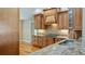 Kitchen with granite countertops, tile backsplash, and stainless steel sink at 15245 Arabian Way, Montverde, FL 34756