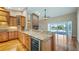 Kitchen area featuring granite counters, wine cooler, and open access to the pool at 15245 Arabian Way, Montverde, FL 34756