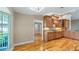 An open kitchen with wooden cabinets, granite countertops, and hardwood flooring at 15245 Arabian Way, Montverde, FL 34756