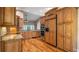 Elegant kitchen featuring wooden cabinets, granite countertops, and stainless steel appliances at 15245 Arabian Way, Montverde, FL 34756