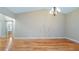 Bright, open living room with hardwood floors and elegant chandelier fixture at 15245 Arabian Way, Montverde, FL 34756