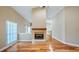 Living room with hardwood floors, fireplace, and window with blinds at 15245 Arabian Way, Montverde, FL 34756