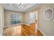Sunlit living room with wood flooring and a view of the backyard and bathroom at 15245 Arabian Way, Montverde, FL 34756