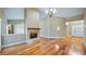Living room with hardwood floors, a fireplace, and an octagonal mirror at 15245 Arabian Way, Montverde, FL 34756