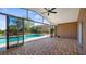 Enclosed brick patio showcases backyard pool and lush landscaping at 15245 Arabian Way, Montverde, FL 34756