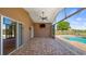Covered patio offers pool views, outdoor TV, ceiling fan, and pavers at 15245 Arabian Way, Montverde, FL 34756