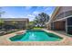 Backyard pool area with brick patio, complemented by the home's architecture and landscaping at 15245 Arabian Way, Montverde, FL 34756