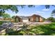 View of the side of home, showing large garage, driveway, and fenced lot with mature trees at 15245 Arabian Way, Montverde, FL 34756