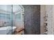 Luxurious shower featuring a glass enclosure, wood bench, and multiple shower heads at 15245 Arabian Way, Montverde, FL 34756