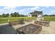 Well-maintained backyard featuring raised garden beds and white farmhouse in the distance at 1560 Ne 17Th St, Sumterville, FL 33585