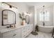 This primary bathroom offers double vanity, soaking tub, and natural light at 1560 Ne 17Th St, Sumterville, FL 33585