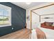 Bedroom featuring a dark accent wall and views of the property at 1560 Ne 17Th St, Sumterville, FL 33585
