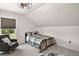 Bedroom featuring a bed with plaid bedding, a gray chair, and a window with blind at 1560 Ne 17Th St, Sumterville, FL 33585