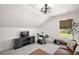Bonus room showcasing modern fan, window with blind, leather sofa, entertainment center, and electronic drum set at 1560 Ne 17Th St, Sumterville, FL 33585