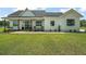 Charming farmhouse features a cozy porch with rocking chairs and a swing, perfect for relaxing outdoors at 1560 Ne 17Th St, Sumterville, FL 33585