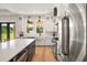 A modern kitchen featuring stainless steel appliances, a large island and views to the outdoors at 1560 Ne 17Th St, Sumterville, FL 33585