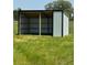 A small shed awaits use on your property surrounded by green grasses at 1560 Ne 17Th St, Sumterville, FL 33585