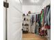 A spacious walk-in closet with custom shelves and metal rack for ample storage space at 1560 Ne 17Th St, Sumterville, FL 33585